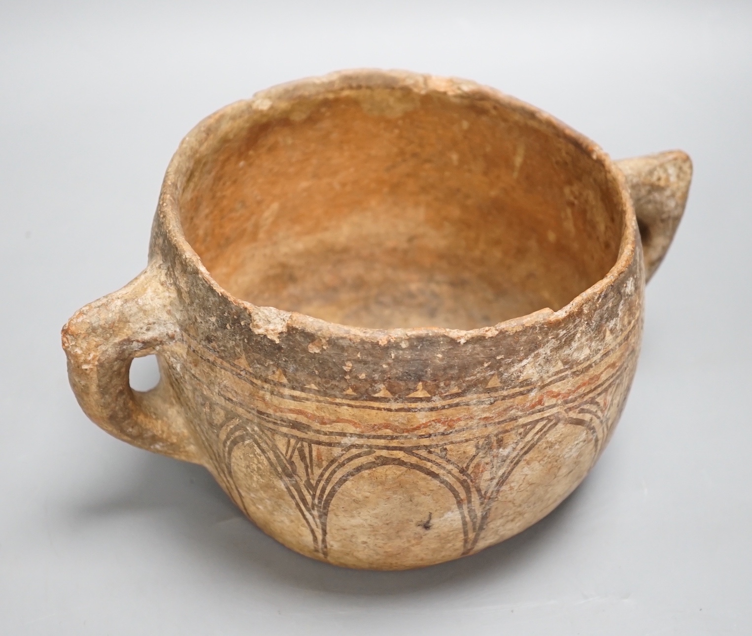 A pre-Columbian two handled terracotta vessel 25cm